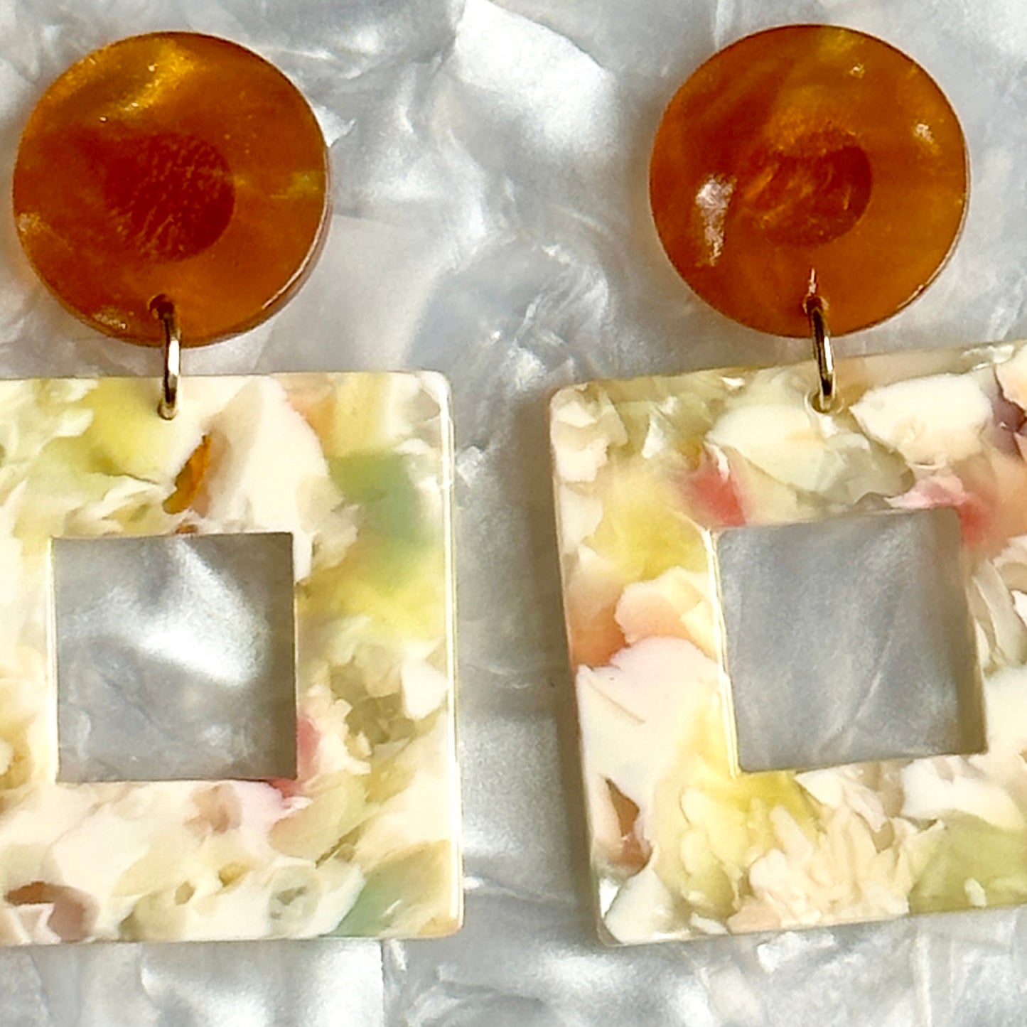 Close up of Acrylic Square Drop Earrings in All Fun and Games, yellow, cream, blue, green and brown 