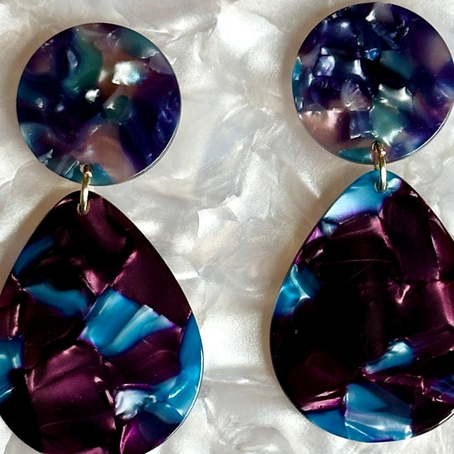 Close up of Acrylic Teardrop Earrings in Walking the Walk, deep blue and purple