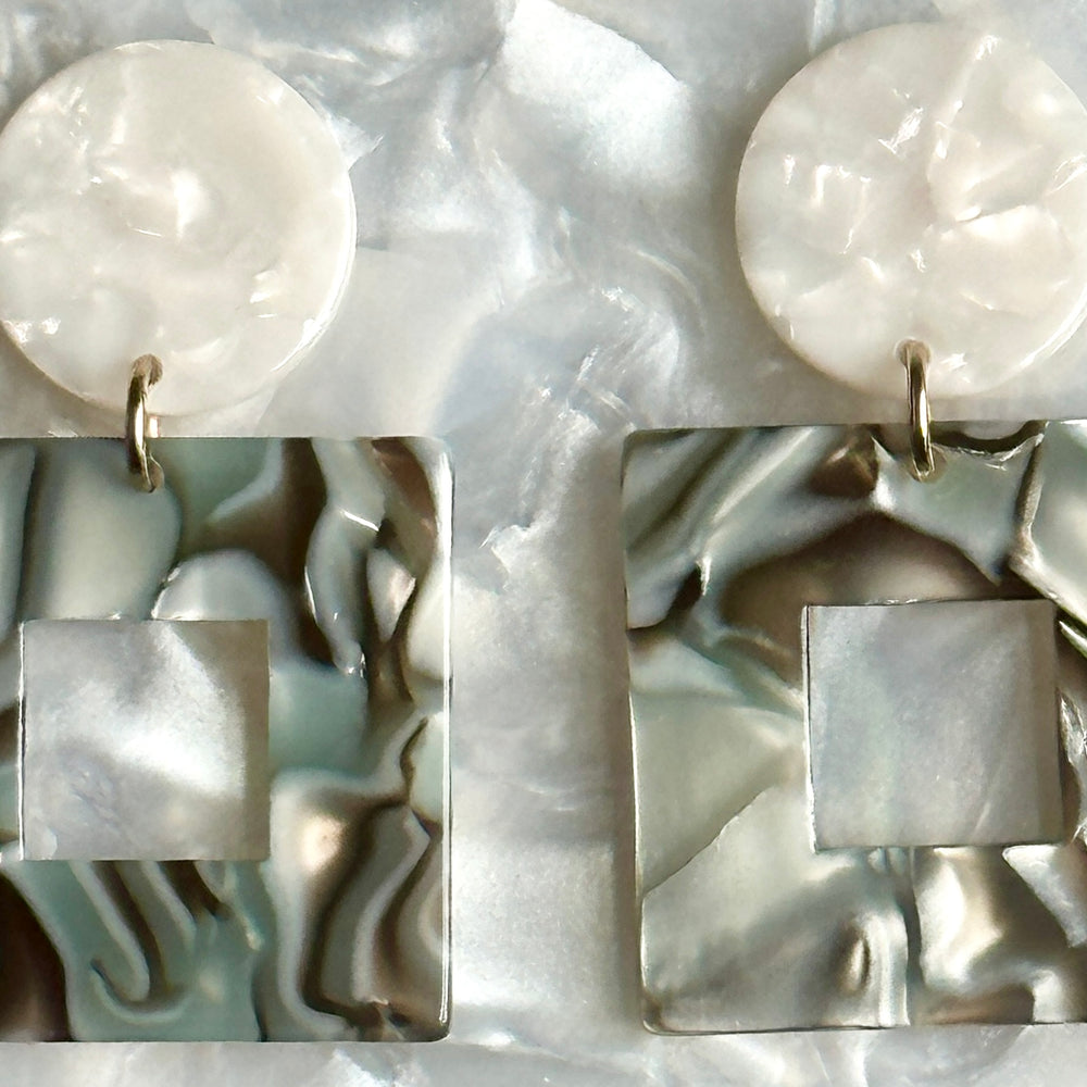 Close up of Small Acrylic Square Drop Earrings in Abalone, blue and gray 