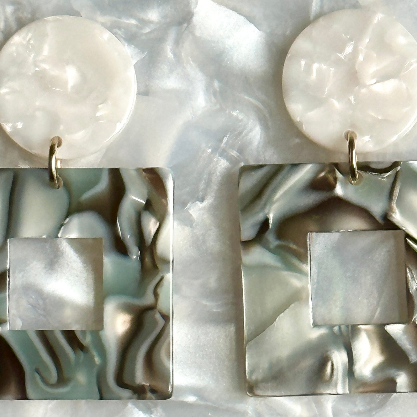 Close up of Small Acrylic Square Drop Earrings in Abalone, blue and gray 