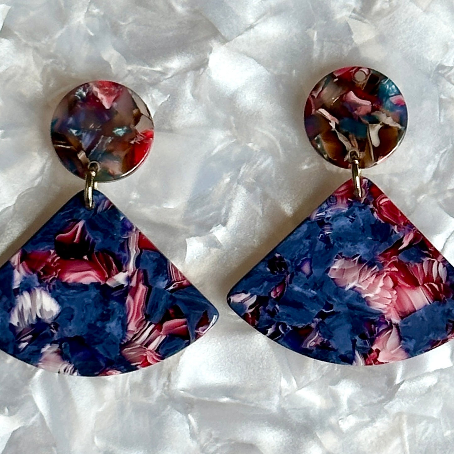 close up of acrylic Fan Drop earring in brown, blue, pink and purple 