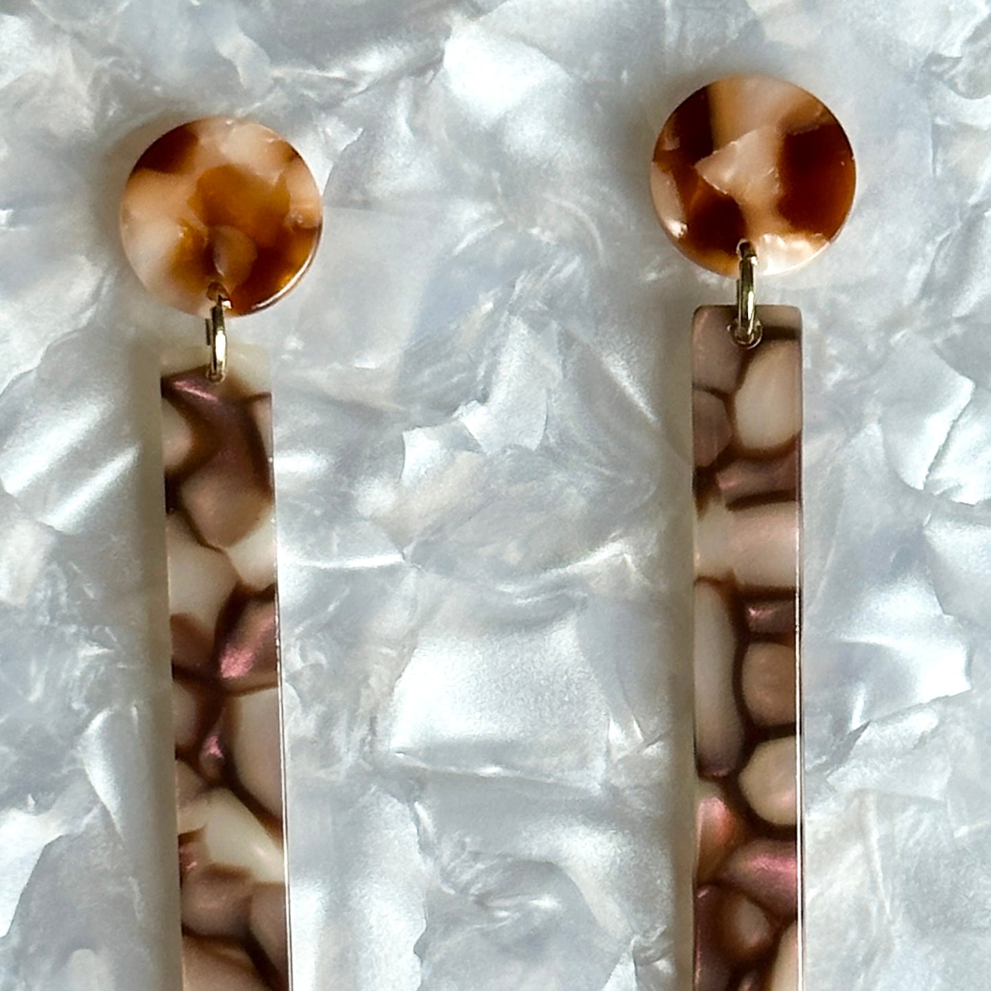 close up of acrylic Matchstick Drop Earrings in Eggplant Crackle purple and brown