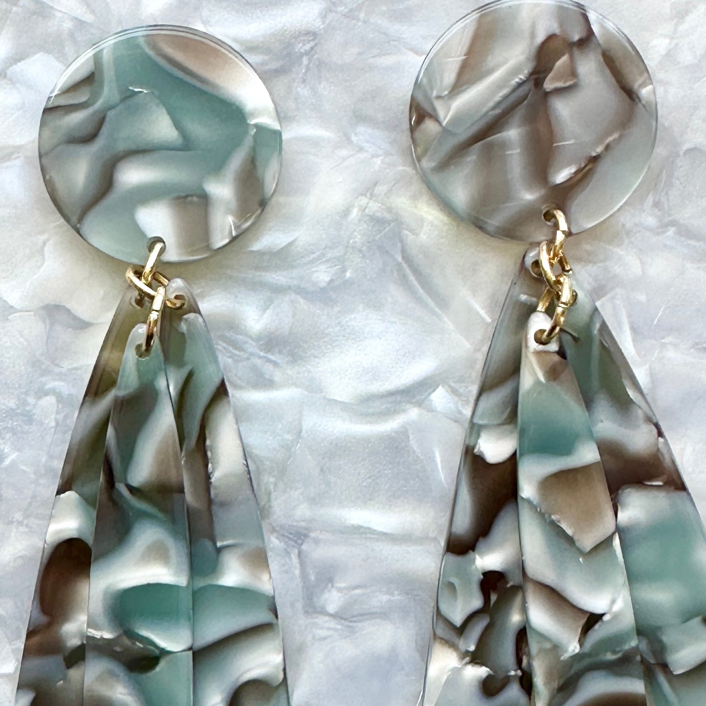 close up of acrylic flower Petal Drop Earrings in Abalone gray and green