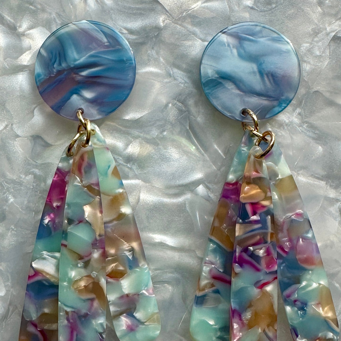 close up of acrylic flower Petal Drop Earrings in blue, purple and pink
