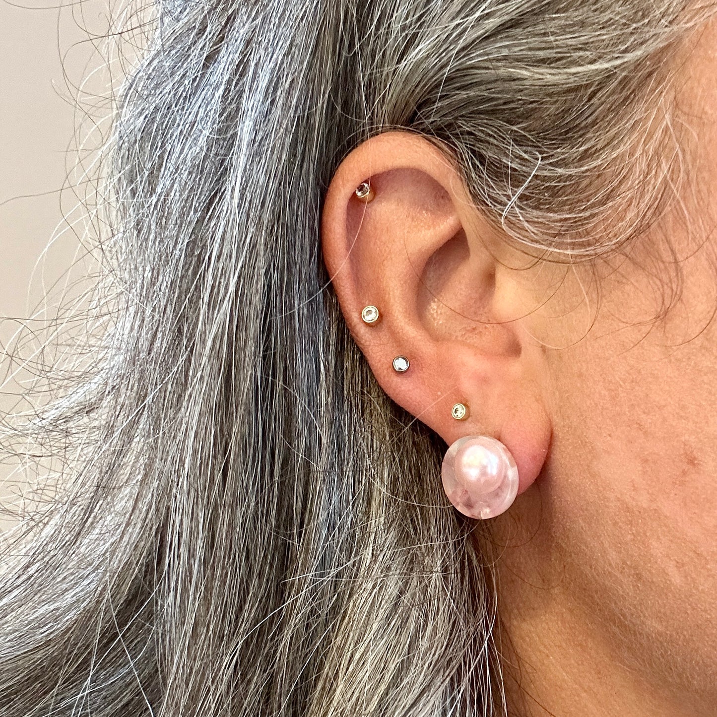 woman wearing acrylic Stud Earrings in light blue and pink